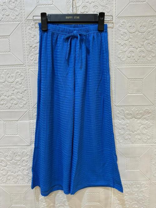 Pantalon bleu fille coupe palazzo, fluide et confortable. Style frais et estival. Du 4 au 14 ans. Idéal pour un look moderne et léger.